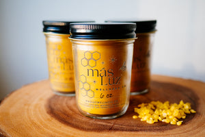 three 8 oz beeswax candle jars with beeswax pellets on the side