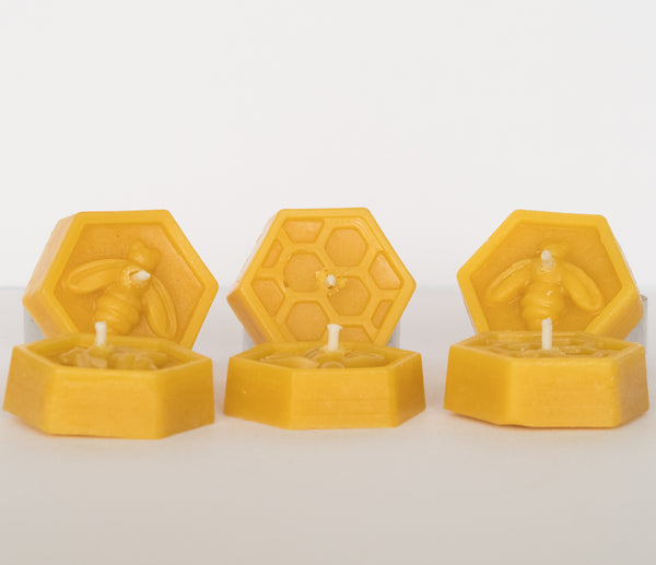 6 beeswax tealight candles with bee & honeycomb design displayed on white