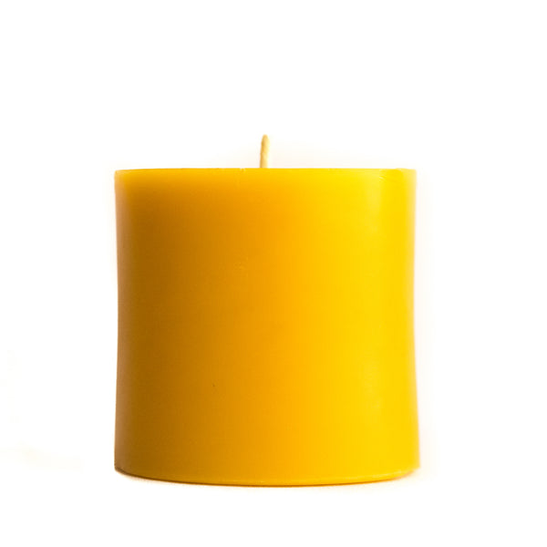 3" by 3" beeswax pillar candle on a white background