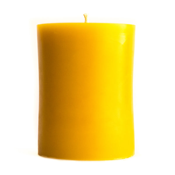 3" by 4" beeswax pillar candle on a white background