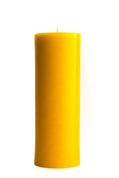 3" by 9" beeswax pillar candle behind a white background